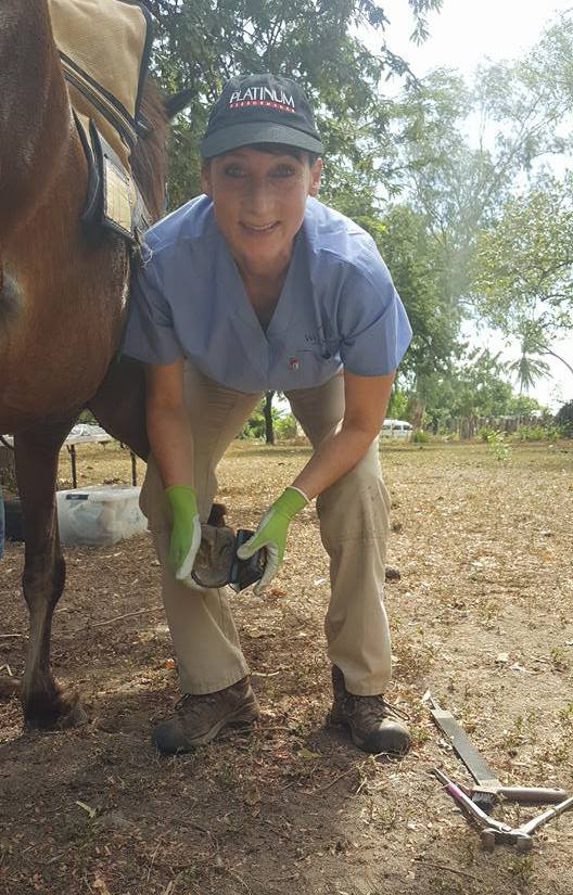 Dr. Dana Bridges-Westerman assisting with hoof care.  The hand-held rasp was donated by Evolutionary Hoof Care based out of Vashon, WA.  Several of these rasps will be left for horse owners to continue hoof care.
