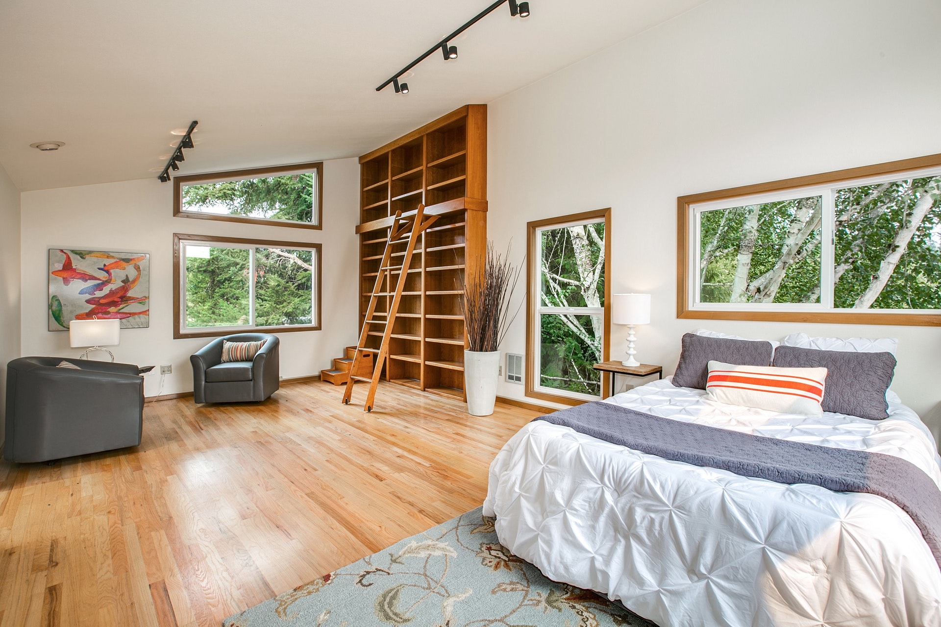 Huge upstairs master suite with full bath and walk in closet enjoy a vaulted ceiling, more picture windows, and a gorgeous hand hewn library bookcase and ladder