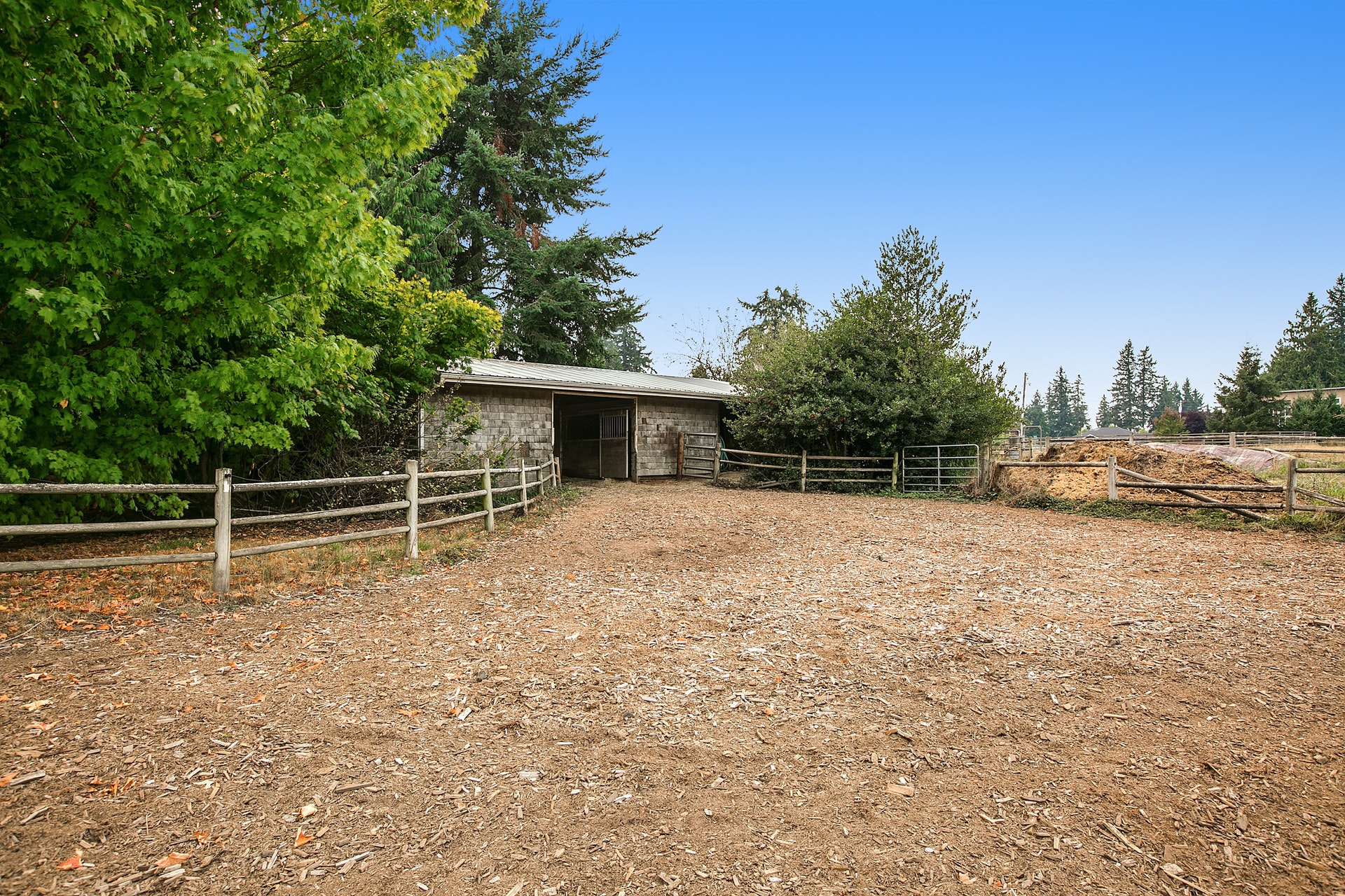 From the paddock to the back of the barn. Barn contains two well designed stables.